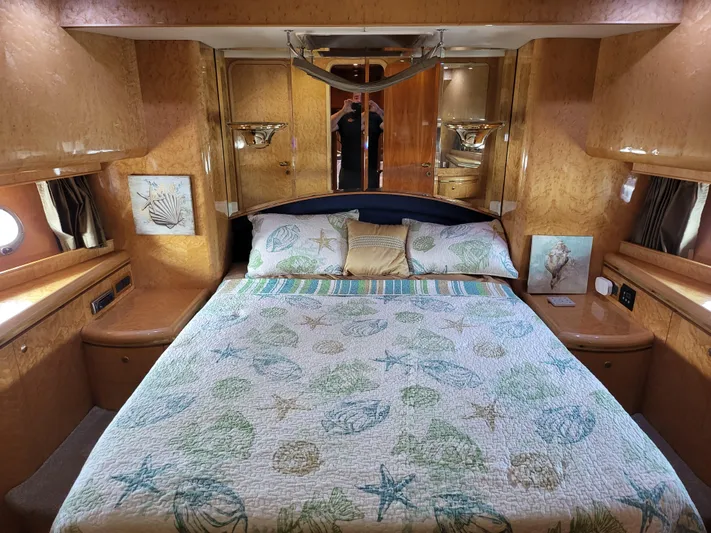  Yacht Photos Pics Luxurious bedroom in 2000 Horizon 74 Motor Yacht with nautical-themed bedding.