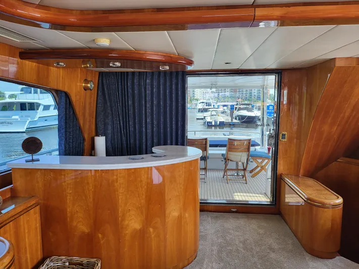  Yacht Photos Pics Luxurious interior of 2000 Horizon 74 Motor Yacht with elegant wood finishes and marina view.