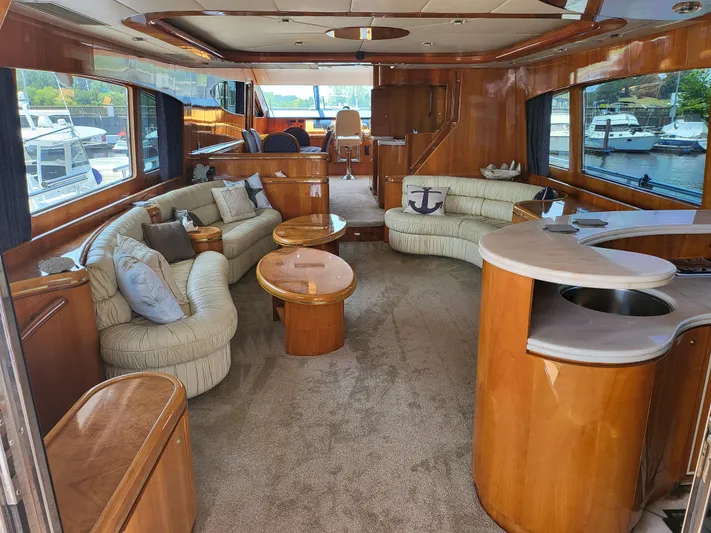  Yacht Photos Pics Luxurious interior of a 2000 Horizon 74 Motor Yacht with elegant seating and wood finishes.