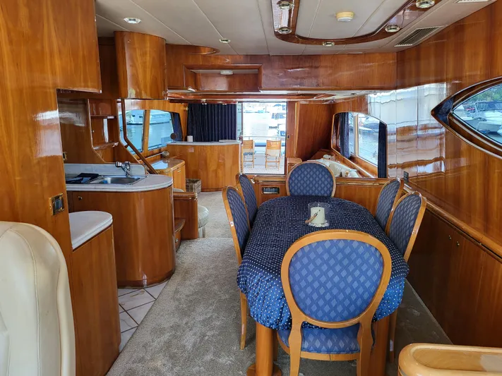 Yacht Photos Pics Luxurious interior of a 2000 Horizon 74 Motor Yacht with elegant wood finishes and dining area.