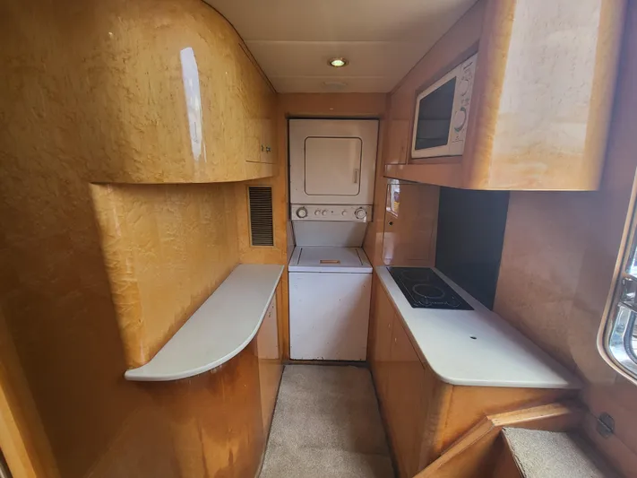  Yacht Photos Pics Interior of 2000 Horizon 74 Motor Yacht with compact kitchen and laundry area.