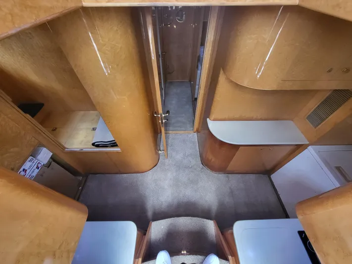 Yacht Photos Pics Interior view of a 2000 Horizon 74 Motor Yacht, featuring wood paneling and carpeted flooring.