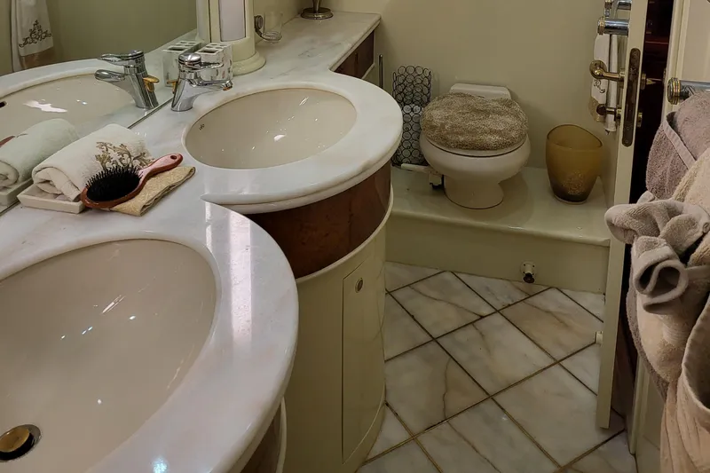  Yacht Photos Pics Luxurious bathroom in 2000 Horizon 74 Motor Yacht with dual sinks and elegant decor.