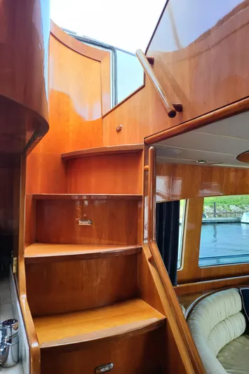  Yacht Photos Pics Wooden staircase inside 2000 Horizon 74 Motor Yacht, leading to upper deck.