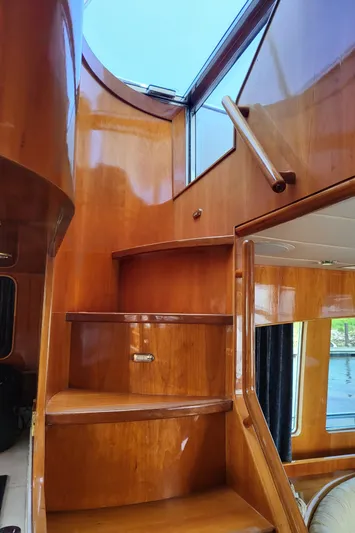  Yacht Photos Pics Interior wooden staircase of 2000 Horizon 74 Motor Yacht with natural light.