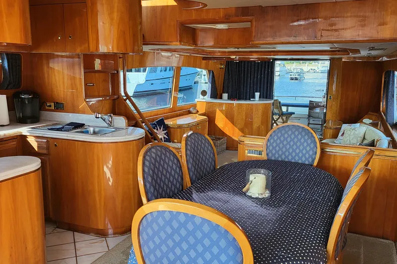  Yacht Photos Pics Luxurious interior of a 2000 Horizon 74 Motor Yacht with elegant wood finishes and dining area.