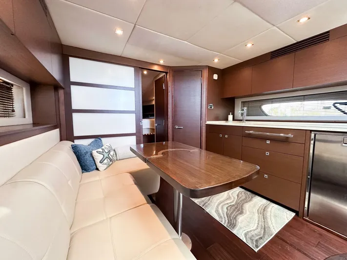 Wine Down Yacht Photos Pics Luxurious interior of 2012 Sea Ray 450 Sundancer yacht with modern kitchen and dining area.