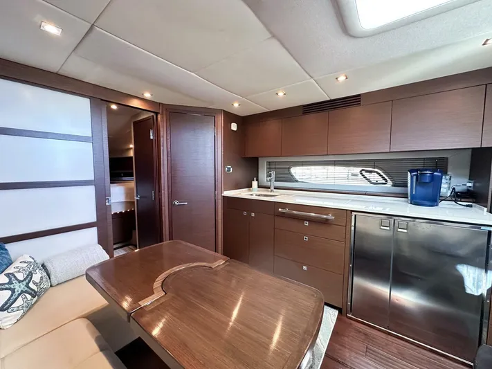 Wine Down Yacht Photos Pics Luxurious interior of 2012 Sea Ray 450 Sundancer yacht with modern kitchen and dining area.