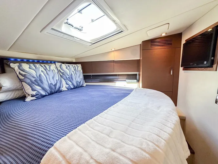 Wine Down Yacht Photos Pics Luxurious cabin interior of 2012 Sea Ray 450 Sundancer yacht with skylight and cozy bedding.