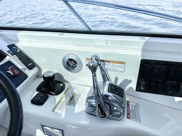 Wine Down Yacht Photos Pics Control panel of 2012 Sea Ray 450 Sundancer boat with throttle levers and navigation controls.