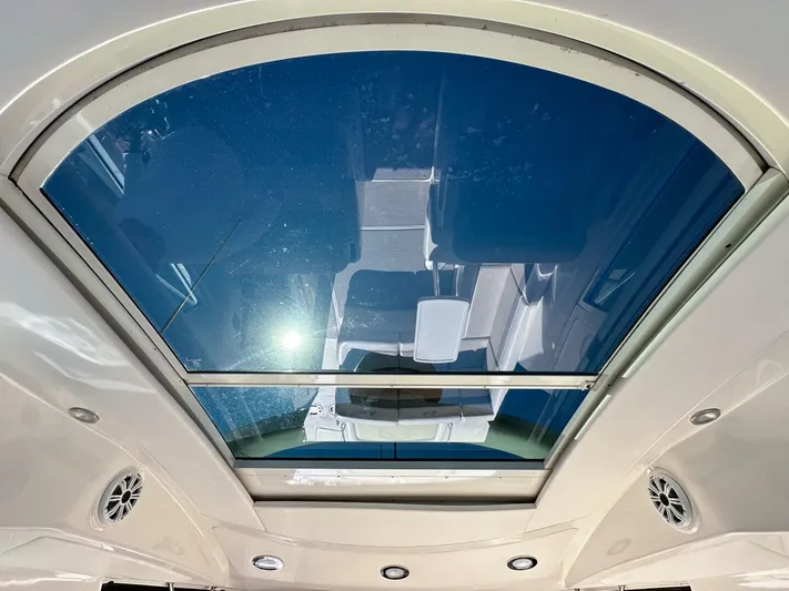 Wine Down Yacht Photos Pics Sunroof view inside 2012 Sea Ray 450 Sundancer yacht, showcasing sleek design and blue sky.