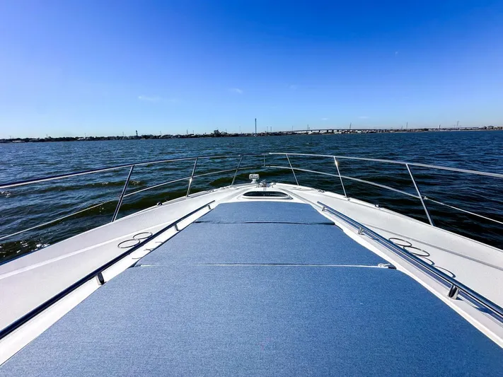 Wine Down Yacht Photos Pics Sea Ray 450 Sundancer 2012 yacht cruising on open water under clear blue sky.