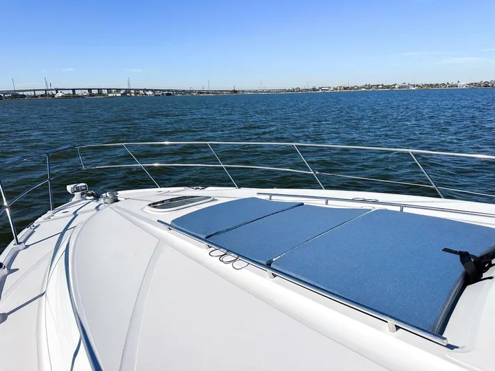 Wine Down Yacht Photos Pics 2012 Sea Ray 450 Sundancer yacht on open water, featuring spacious deck and scenic view.
