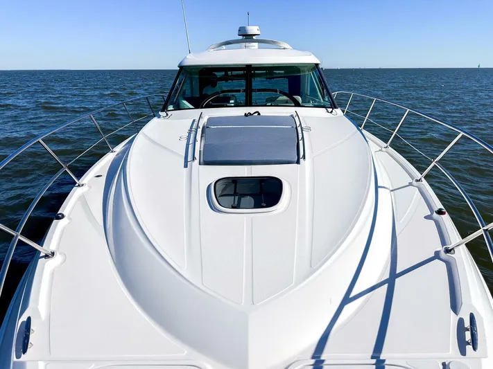 Wine Down Yacht Photos Pics 2012 Sea Ray 450 Sundancer yacht on open water, showcasing sleek design and spacious deck.