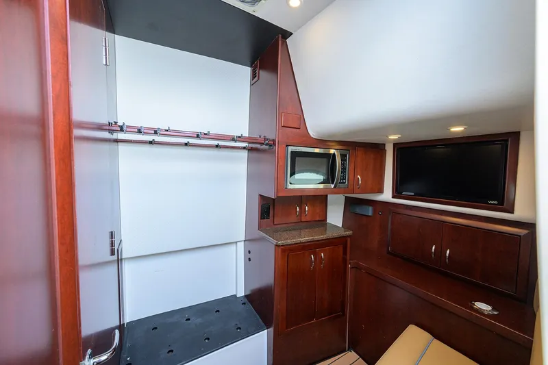 Tales N' Ales Yacht Photos Pics 2018 Buddy Davis 42 Center Console Cabin with microwave, TV, and cabinetry.