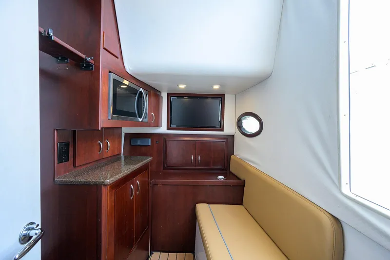 Tales N' Ales Yacht Photos Pics Interior of 2018 Buddy Davis 42 Center Console with galley and seating area.