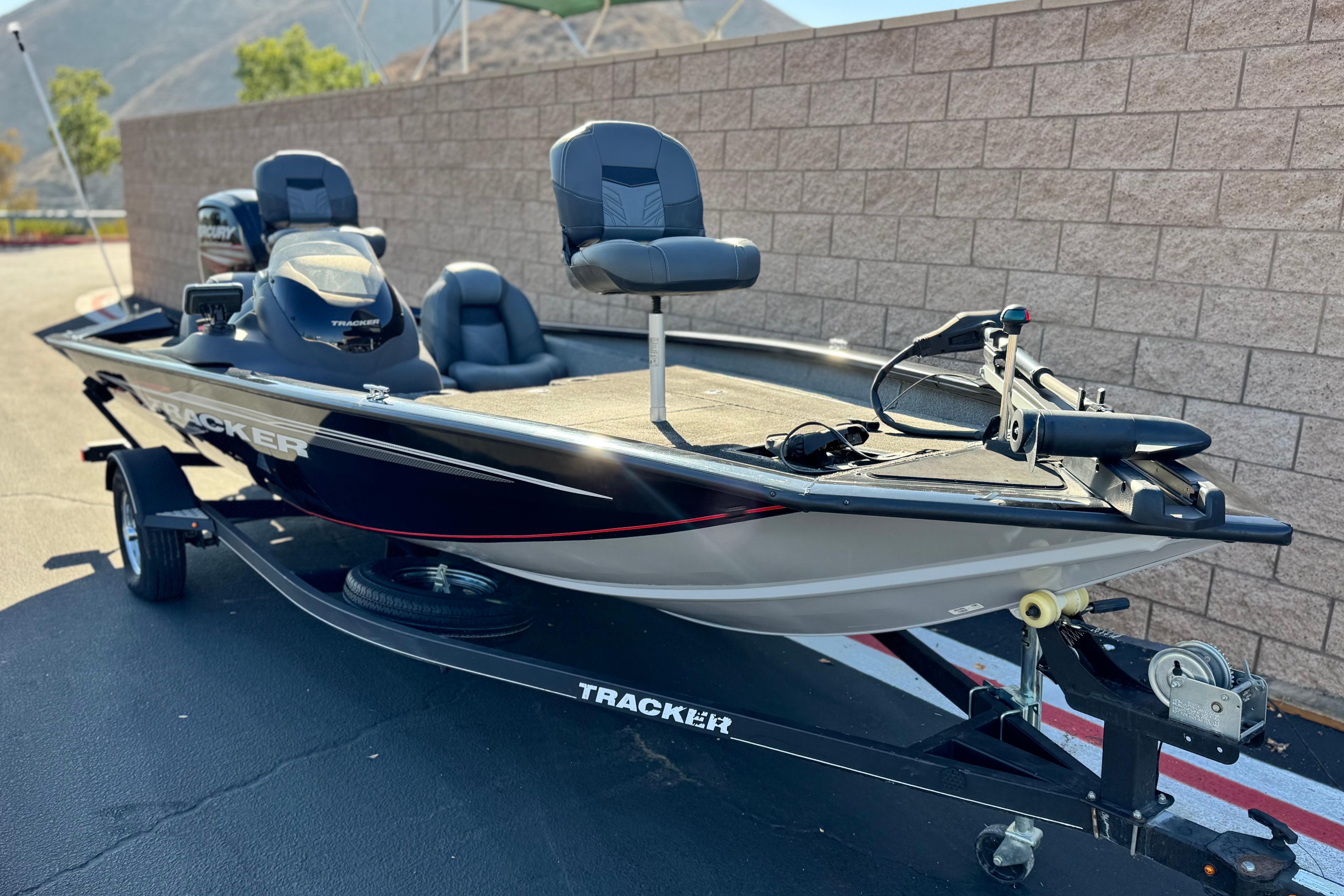 2019 Tracker Pro Team 175 boat on trailer, parked outdoors near a brick wall.