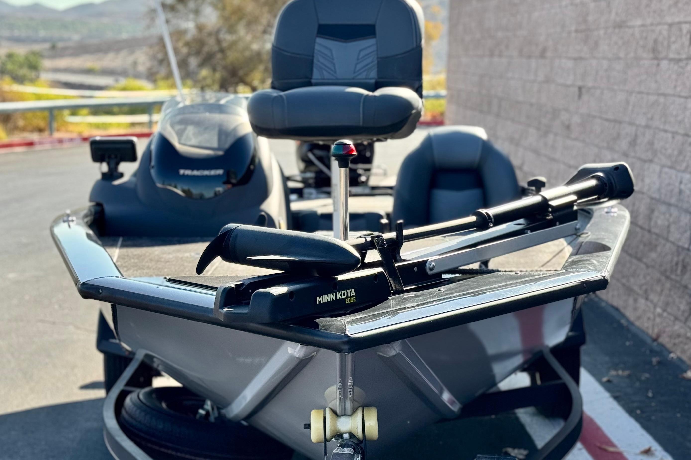 2019 Tracker Pro Team 175 boat with Minn Kota trolling motor, parked outdoors.