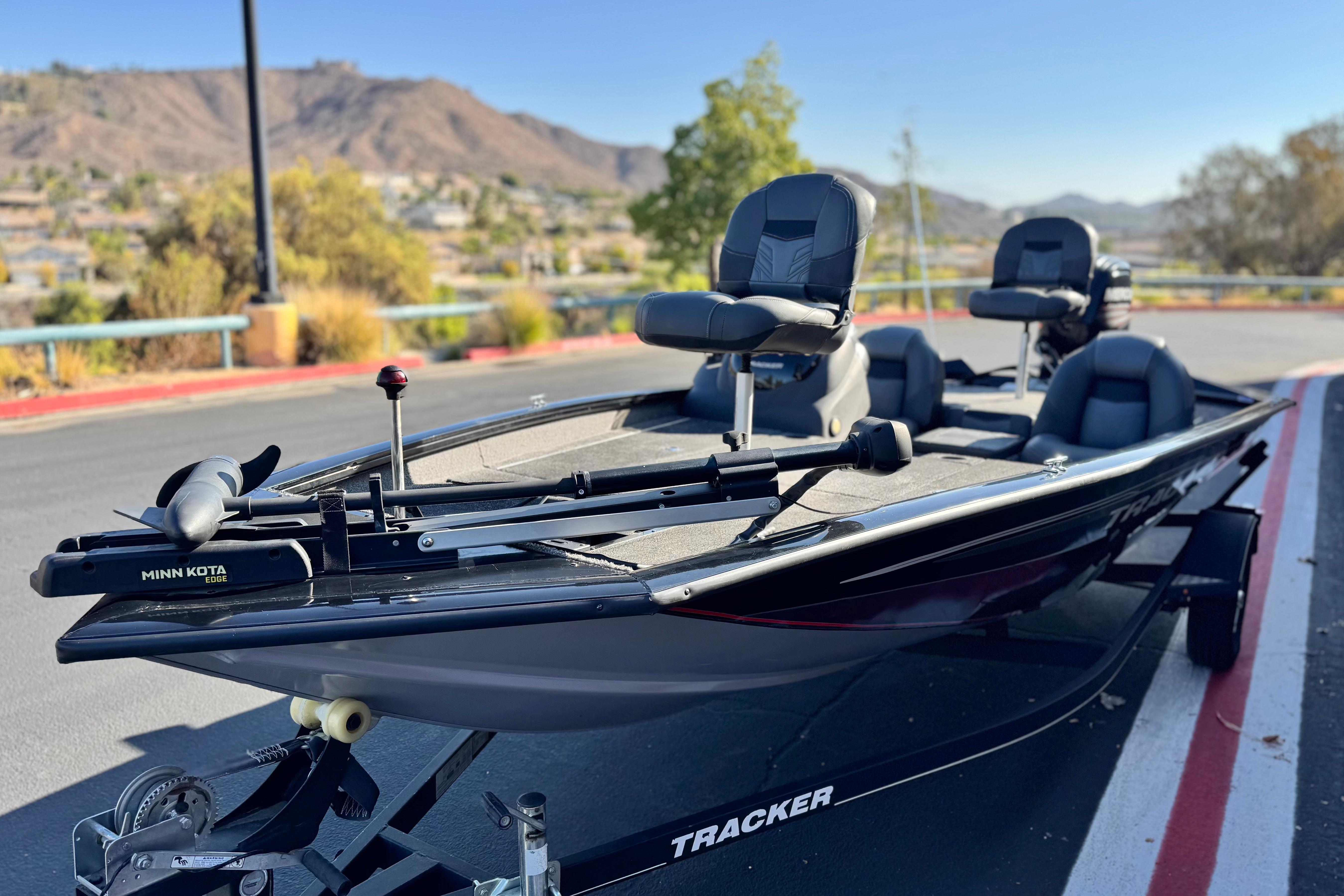 2019 Tracker Pro Team 175 boat with Minn Kota motor, parked outdoors.