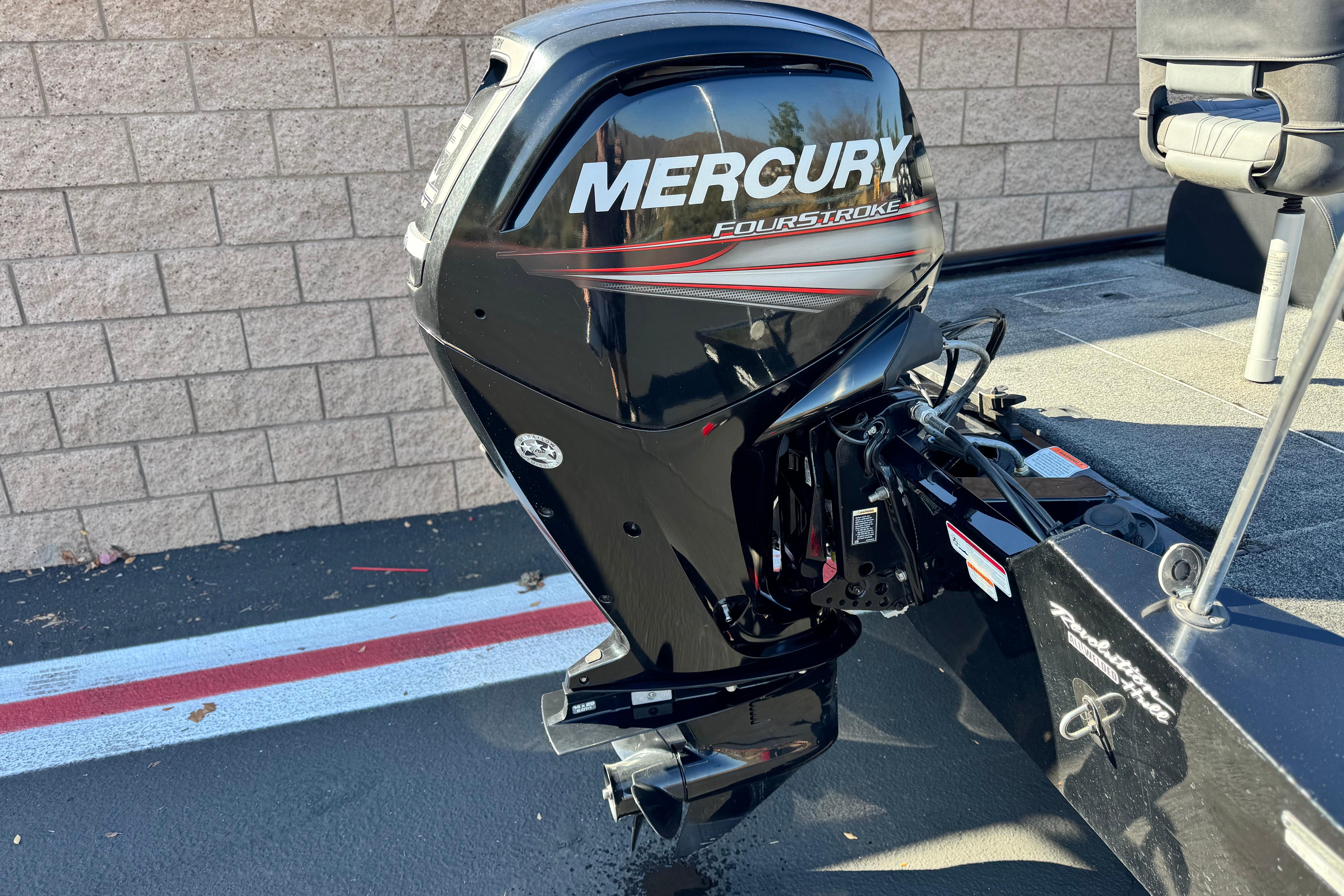 2019 Tracker Pro Team 175 with Mercury FourStroke outboard motor, parked on pavement.