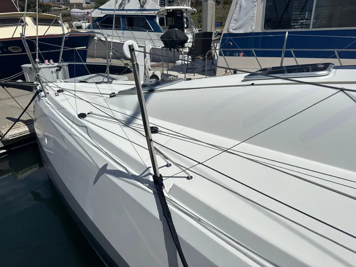 Rebel Yacht Photos Pics 2021 Jeanneau Sun Fast 3300 sailboat docked at marina, showcasing sleek design and rigging.