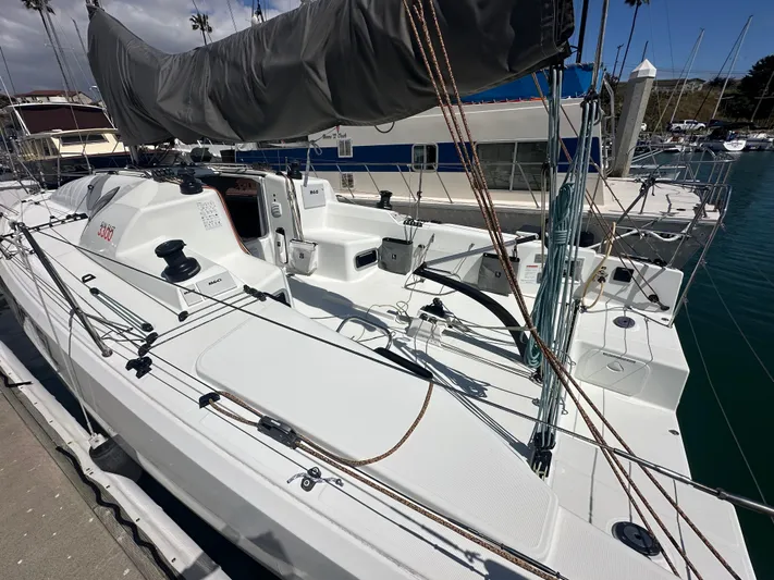 Rebel Yacht Photos Pics 2021 Jeanneau Sun Fast 3300 sailboat docked at marina, showcasing sleek deck design.