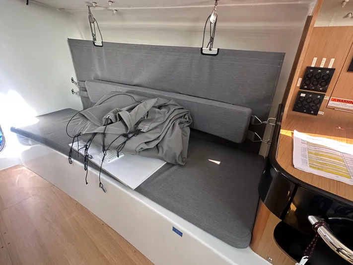 Rebel Yacht Photos Pics Interior of 2021 Jeanneau Sun Fast 3300 sailboat with gray seating and control panel.