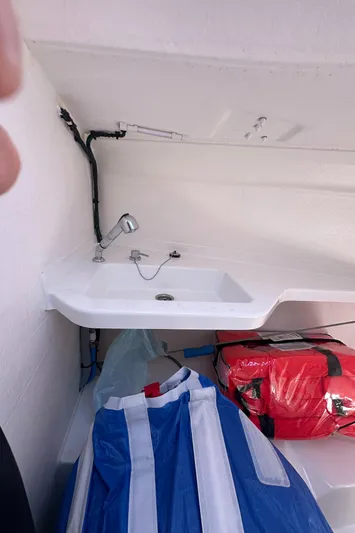 Rebel Yacht Photos Pics 2021 Jeanneau Sun Fast 3300 interior with sink and storage area.