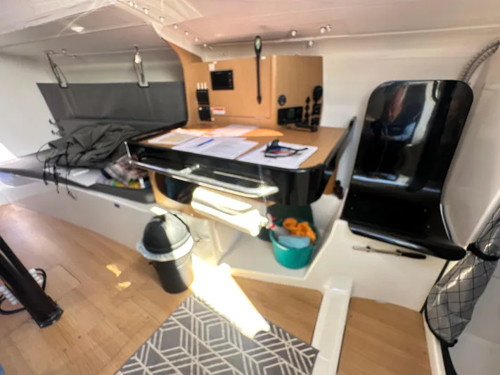 Rebel Yacht Photos Pics Interior of 2021 Jeanneau Sun Fast 3300 sailboat with navigation station and seating area.