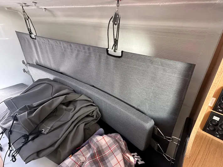 Rebel Yacht Photos Pics Interior of 2021 Jeanneau Sun Fast 3300 sailboat with cushions and folded sails.