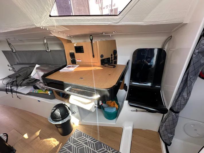 Rebel Yacht Photos Pics Interior of 2021 Jeanneau Sun Fast 3300 sailboat with navigation station and seating.