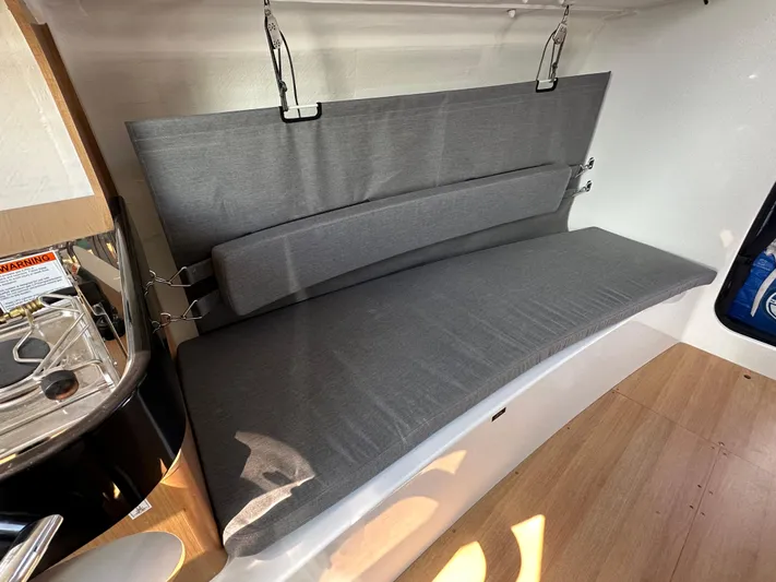 Rebel Yacht Photos Pics Interior of 2021 Jeanneau Sun Fast 3300 sailboat with gray cushioned seating.