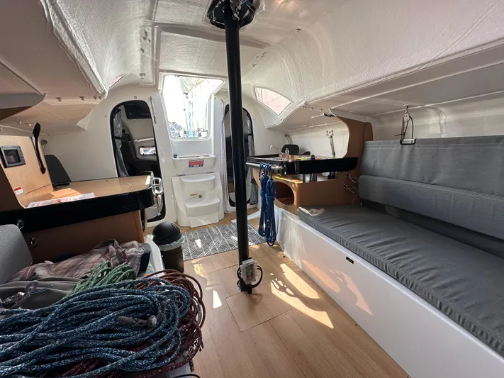 Rebel Yacht Photos Pics Interior of 2021 Jeanneau Sun Fast 3300 sailboat with seating and ropes.