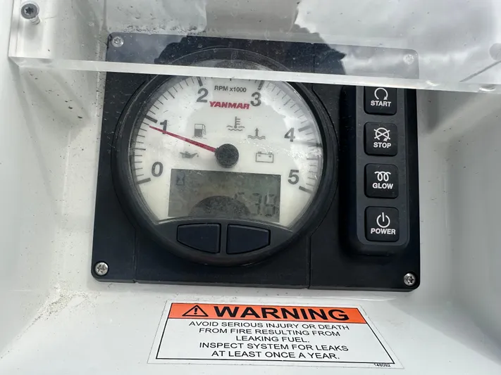 Rebel Yacht Photos Pics Control panel of a 2021 Jeanneau Sun Fast 3300 with Yanmar RPM gauge and warning label.