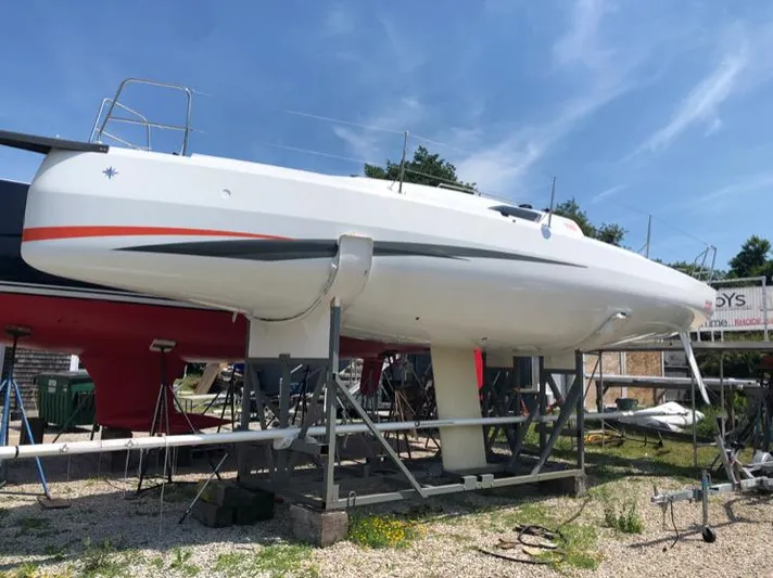 Rebel Yacht Photos Pics 2021 Jeanneau SUNFAST 3300 sailboat on dry dock under clear blue sky.