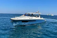 2023 Nimbus W11 boat cruising on clear blue ocean waters.