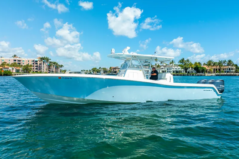  Yacht Photos Pics 2016 Invincible 39 boat cruising on clear blue water under a sunny sky.