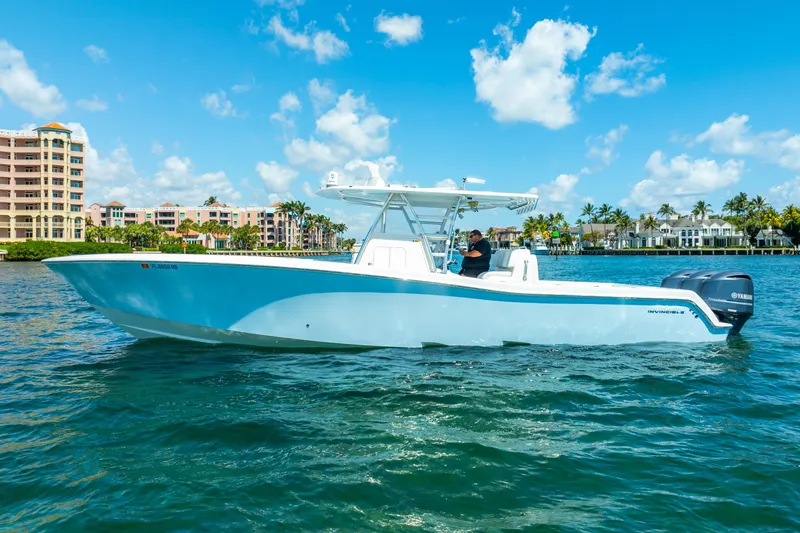  Yacht Photos Pics 2016 Invincible 39 boat cruising on clear blue water under a sunny sky.