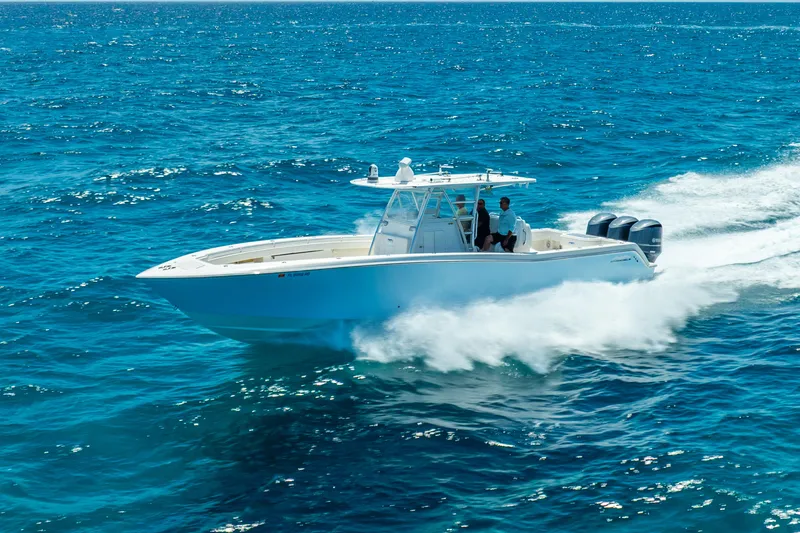  Yacht Photos Pics 2016 Invincible 39 boat cruising on open blue ocean waters.