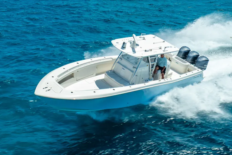  Yacht Photos Pics 2016 Invincible 39 boat cruising on clear blue ocean waters.