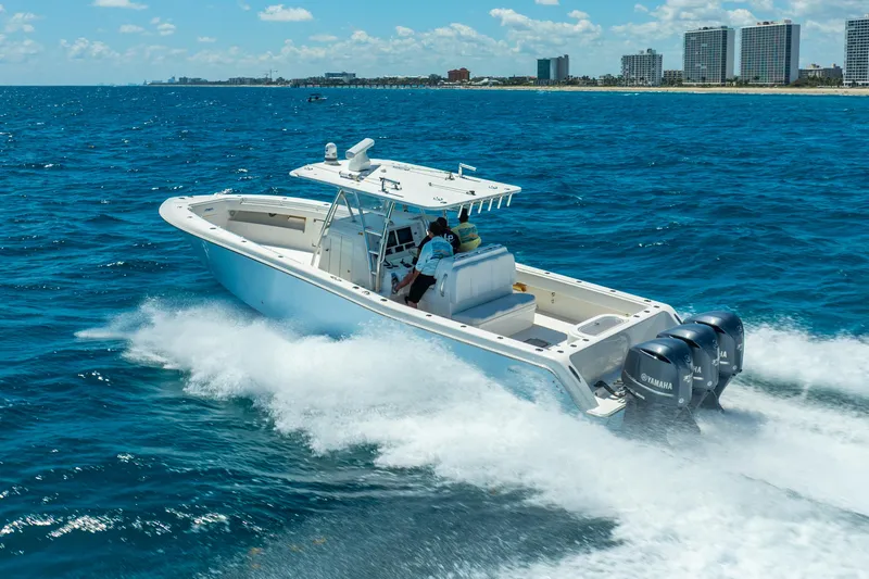  Yacht Photos Pics 2016 Invincible 39 boat cruising on ocean near city skyline.