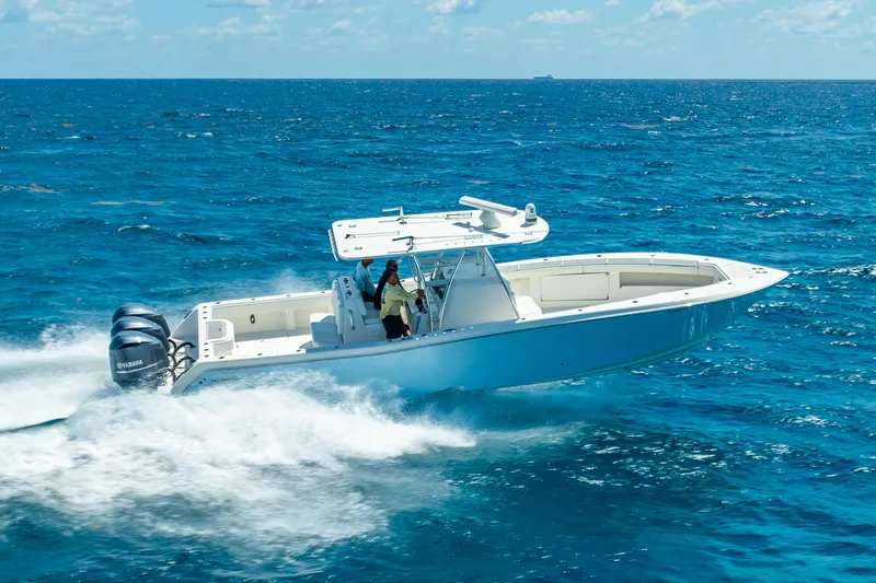  Yacht Photos Pics 2016 Invincible 39 boat cruising on open ocean with clear blue skies.