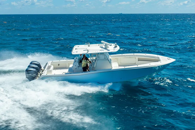  Yacht Photos Pics 2016 Invincible 39 boat cruising on open ocean with triple outboard engines.