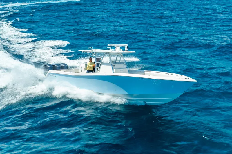  Yacht Photos Pics 2016 Invincible 39 boat cruising on open blue ocean waters.