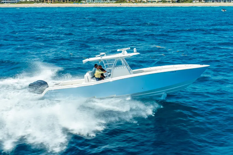  Yacht Photos Pics 2016 Invincible 39 boat cruising swiftly on open blue ocean waters.