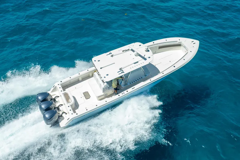  Yacht Photos Pics 2016 Invincible 39 boat cruising on clear blue ocean waters.