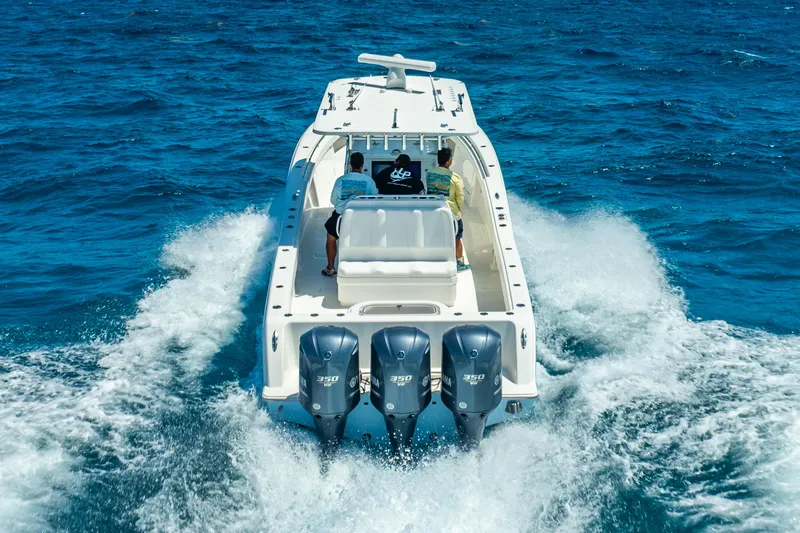  Yacht Photos Pics 2016 Invincible 39 boat cruising on open blue water with triple engines.