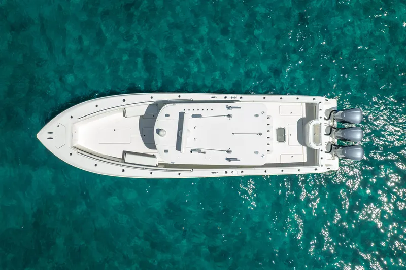  Yacht Photos Pics Aerial view of 2016 Invincible 39 boat on clear turquoise water.