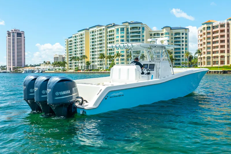  Yacht Photos Pics 2016 Invincible 39 boat with Yamaha engines on water, cityscape background.