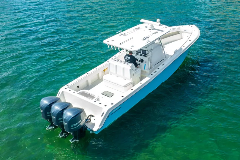  Yacht Photos Pics 2016 Invincible 39 boat with triple Yamaha engines on clear water.